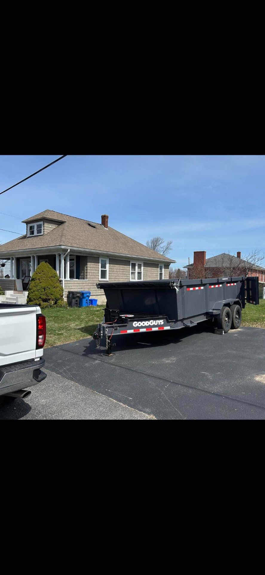 A&M Site Services dump trailer dropped off in a residential driveway